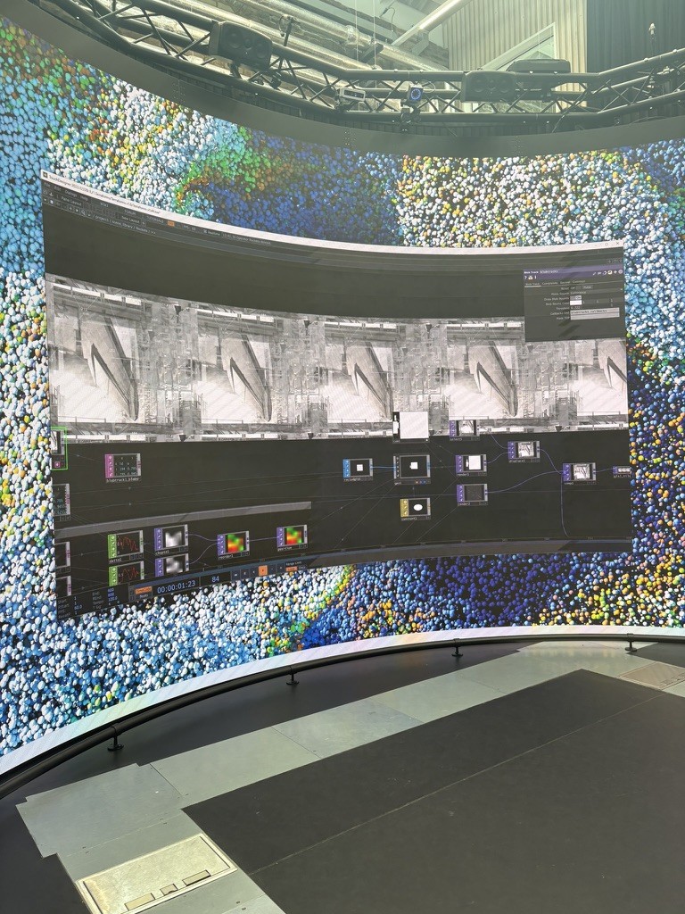 A TouchDesigner scene being tested and previewed on the curved Reality Emulator screen.